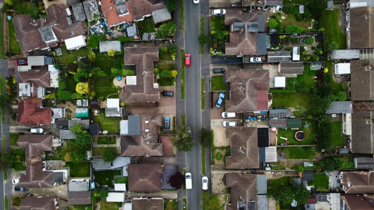 Drone shot capturing the houses and streets in a suburban area of Luton, England.